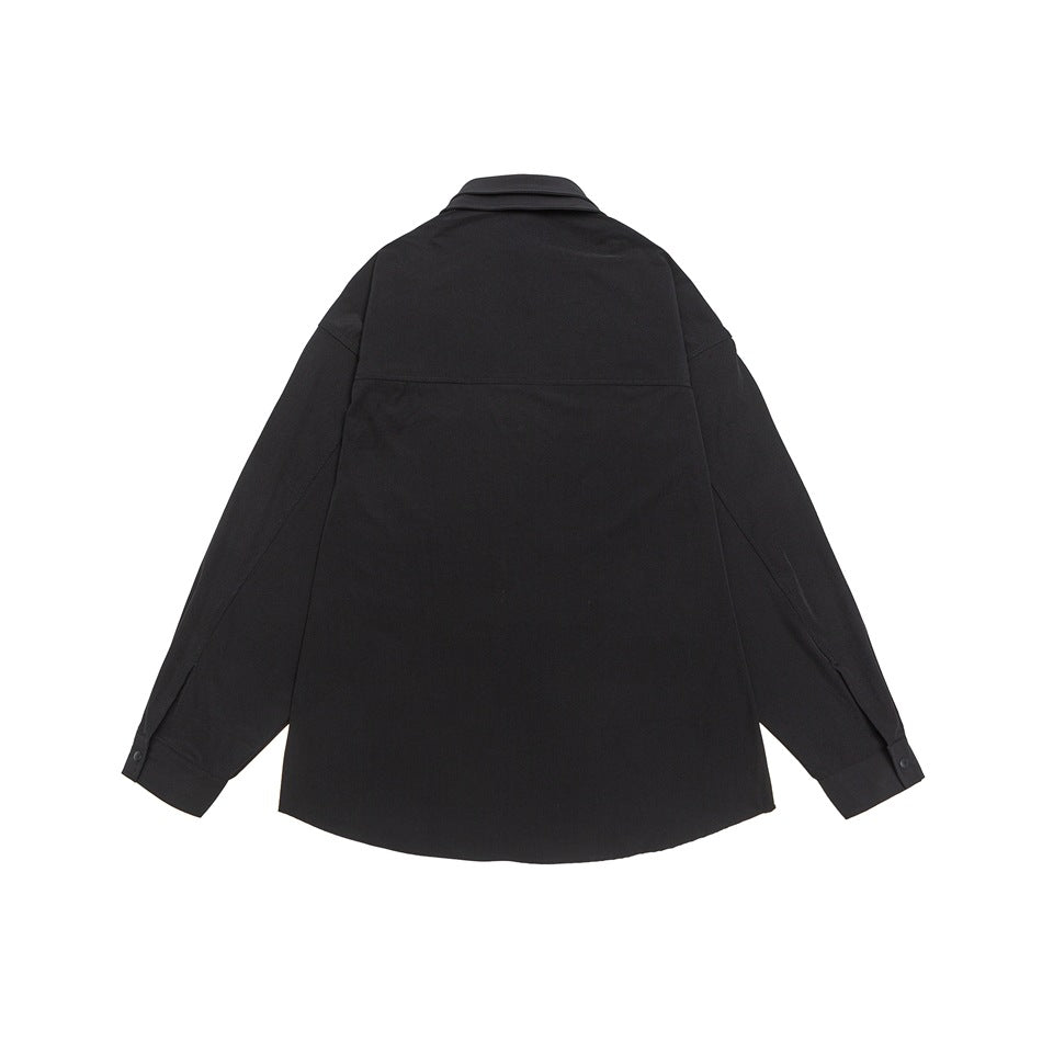 Back view of a black long-sleeve collared shirt laid flat, with a yoke seam and buttoned cuffs.