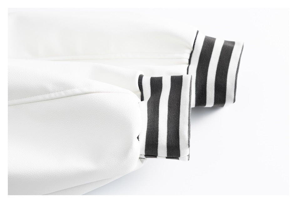 Close-up of white jacket sleeves with black-and-white striped ribbed cuffs.