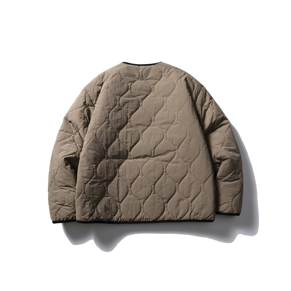 Back view of a taupe quilted jacket with rounded stitched panels and black edging, laid flat on white.