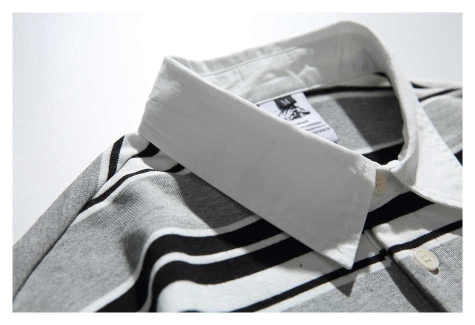 Close-up of the shirt's white pointed collar and striped shoulder, with the neck label visible.