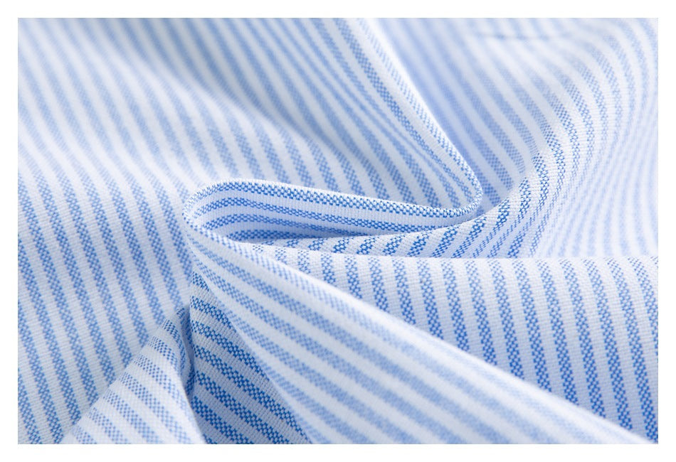 Close-up of white fabric with narrow blue stripes gathered into folds.
