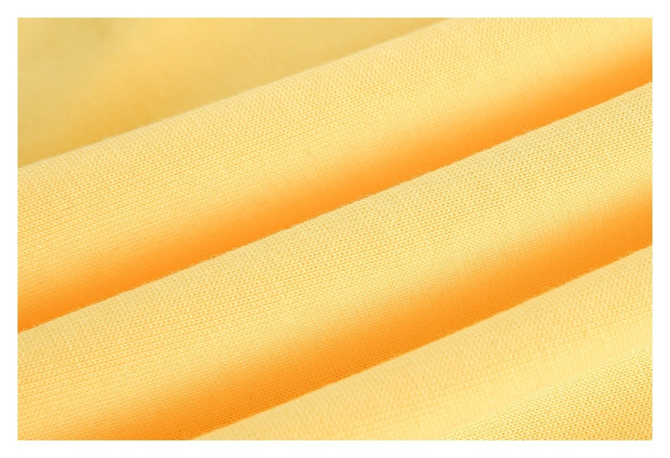 Extreme close-up of the textured yellow fabric folded into ridges.
