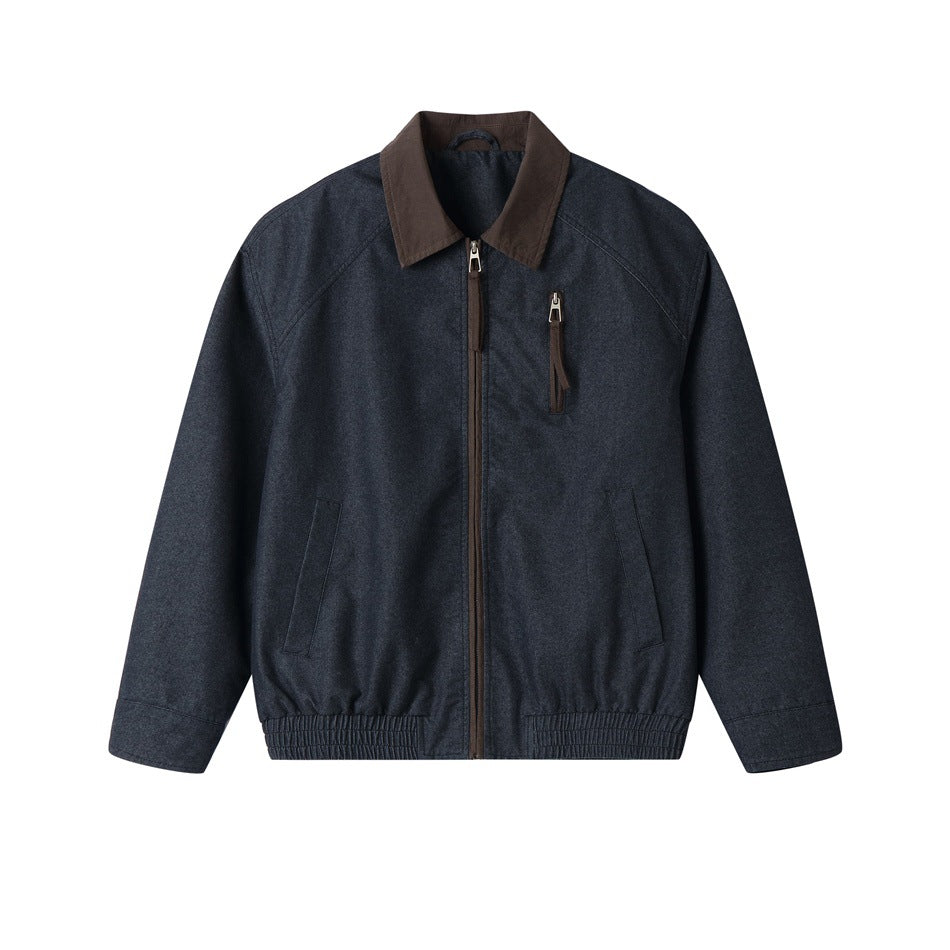 Denim-blue zip-front jacket with brown collar, chest zip pocket and elastic hem, shown flat from the front