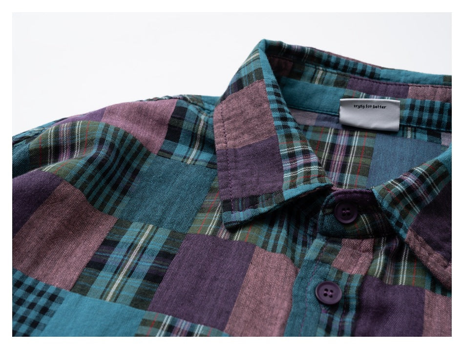 Close-up of a teal and purple patchwork plaid shirt collar, buttons, and neck label.