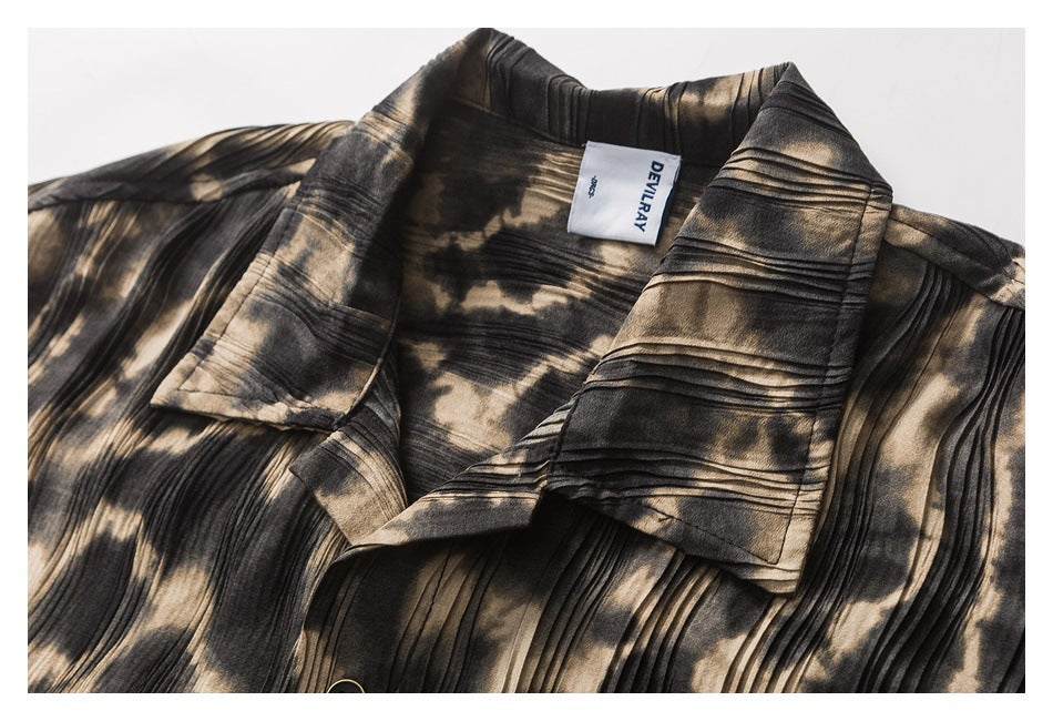 Close-up of a black and tan patterned shirt collar and sewn-in neck label.