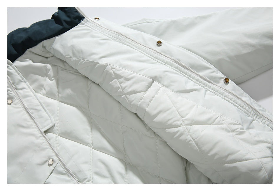 White jacket opened to show its diamond-quilted lining, zipper, and snap-button placket.