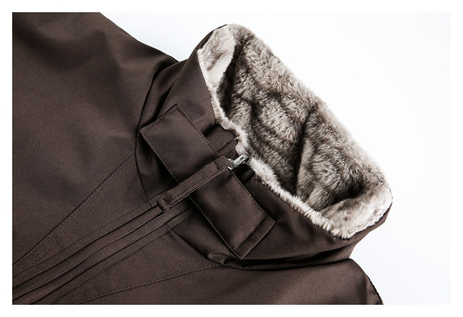 Close-up of a dark brown coat hood lined with gray striped faux fur and secured with a strap.