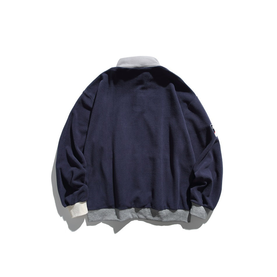 Back view of a navy pullover laid flat, with a gray collar and hem and light cuffs.