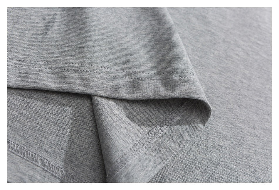 Close-up of the heather-gray T-shirt hem, stitching, and inside seam finish.