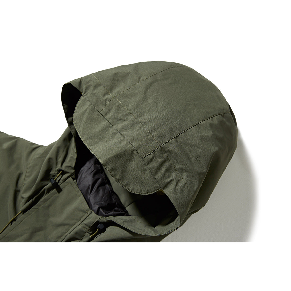 Close-up of an olive hooded jacket showing the hood seams, dark lining, and adjustable drawcord.