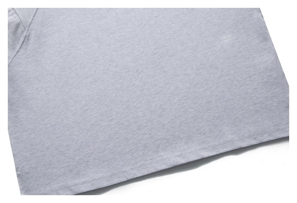 Close-up of light gray knit fabric and a straight stitched hem.