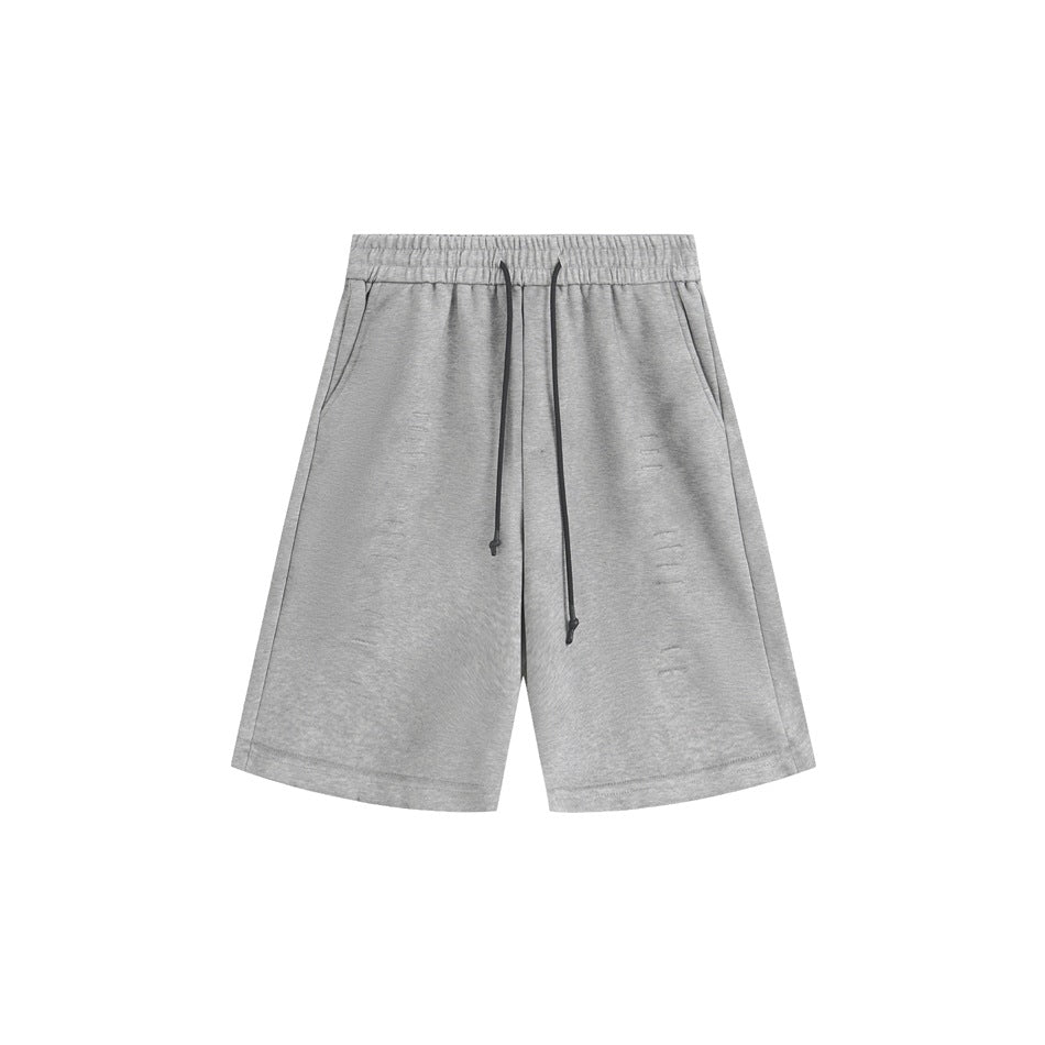 Gray knee-length drawstring shorts with elastic waistband, side pockets and small distressed slashes, front view