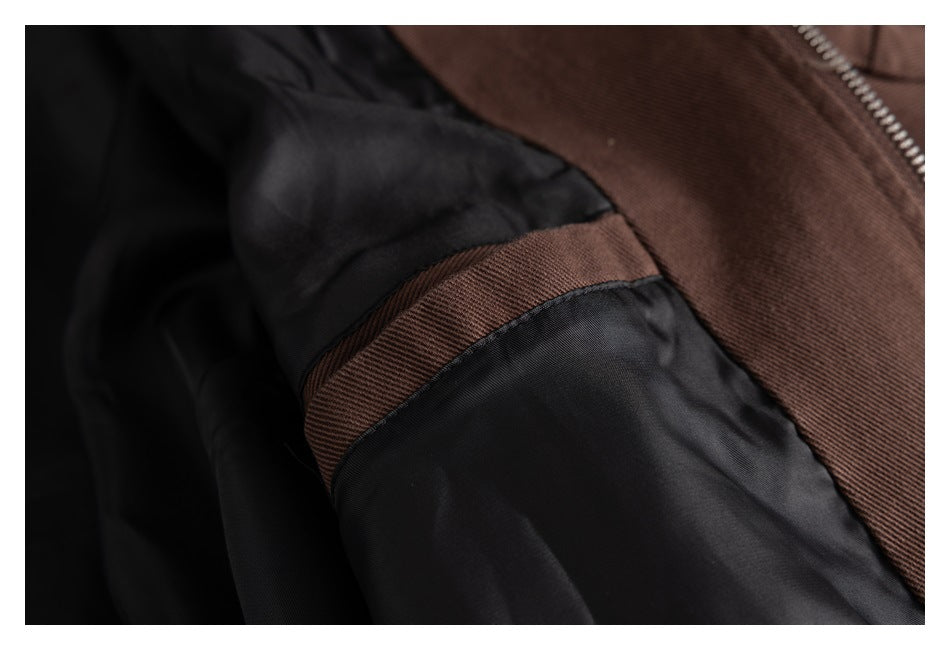 Close-up of the jacket's black lining and brown fabric seam near the zipper.