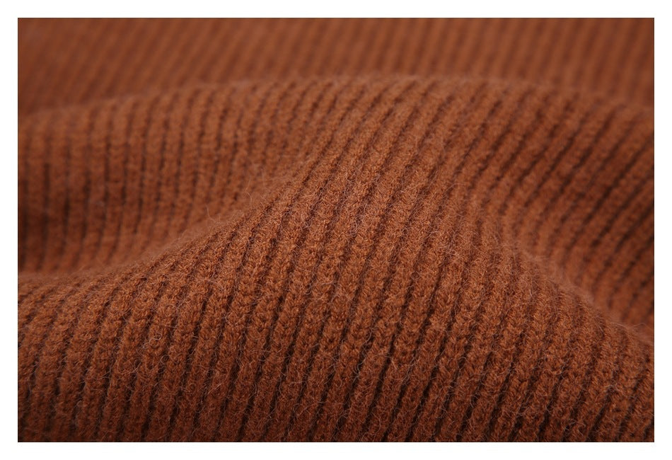Close-up showing the fuzzy surface and ribbed knit texture of rust-brown fabric.