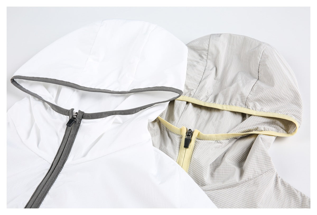 Close-up of two hooded jacket hoods with contrasting trim and front zippers, one white and one light gray striped.