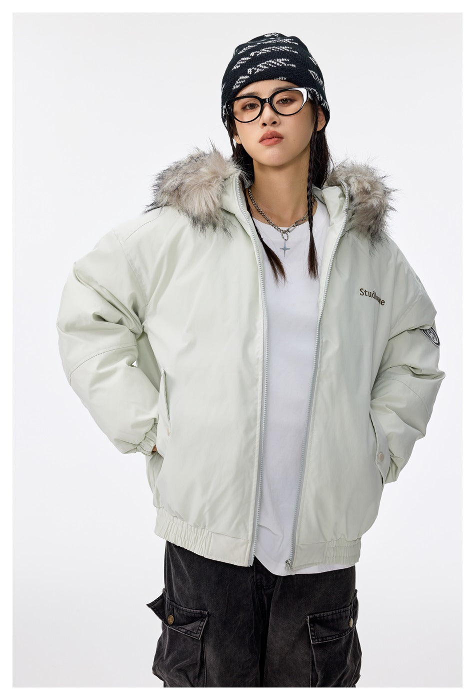 Model wearing an open pale mint hooded jacket with gray faux-fur trim, elastic hem, and flap pockets.