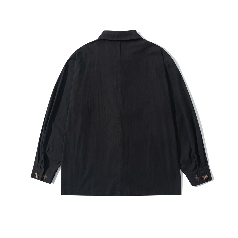 Back view of black long-sleeve shirt with center back seam and toggle-button cuffs