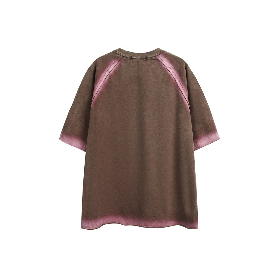 Back of a brown oversized short-sleeve raglan shirt with mauve fading along the seams, sleeves and hem.