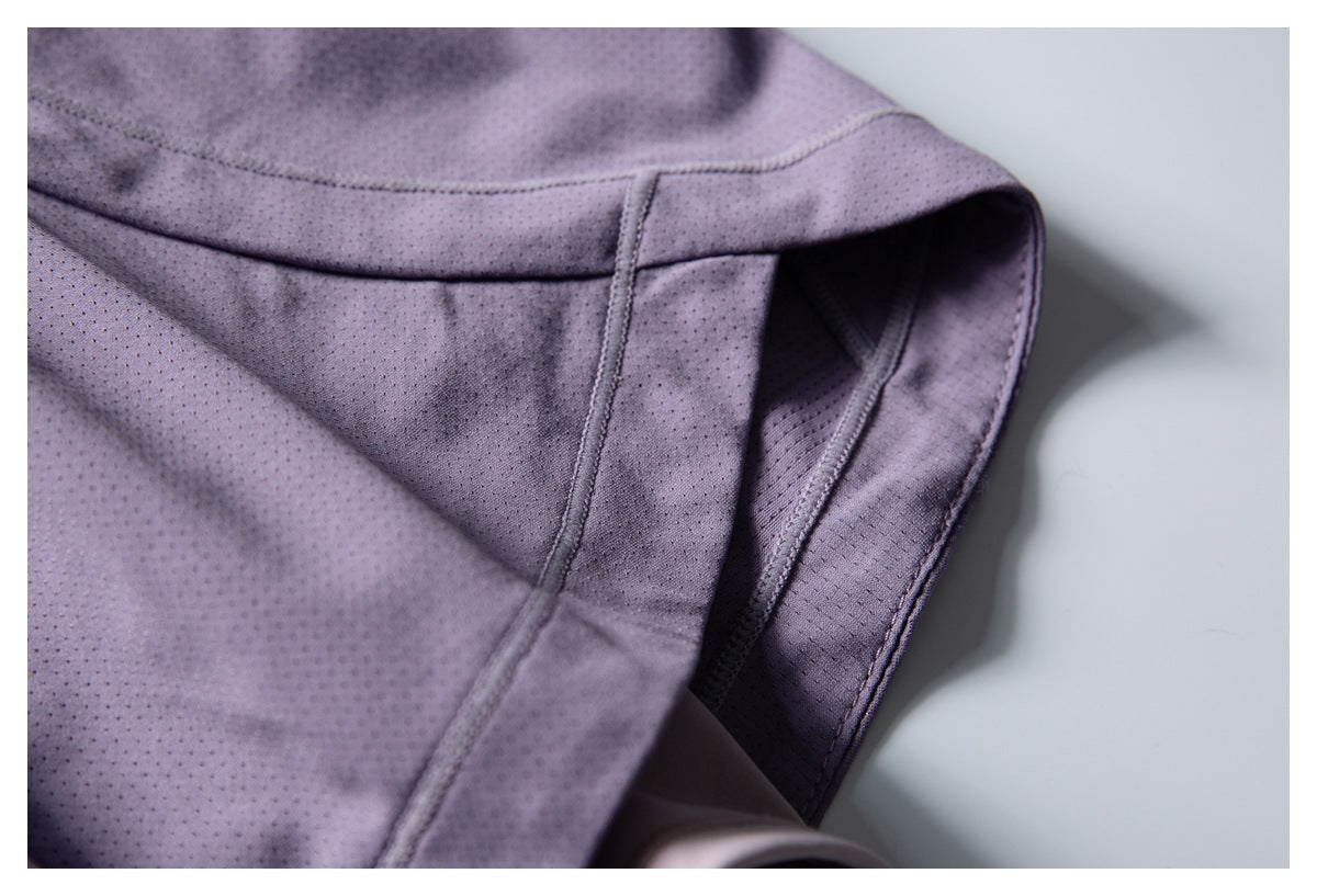 Close-up of a lavender shorts pocket opening and reinforced stitching.