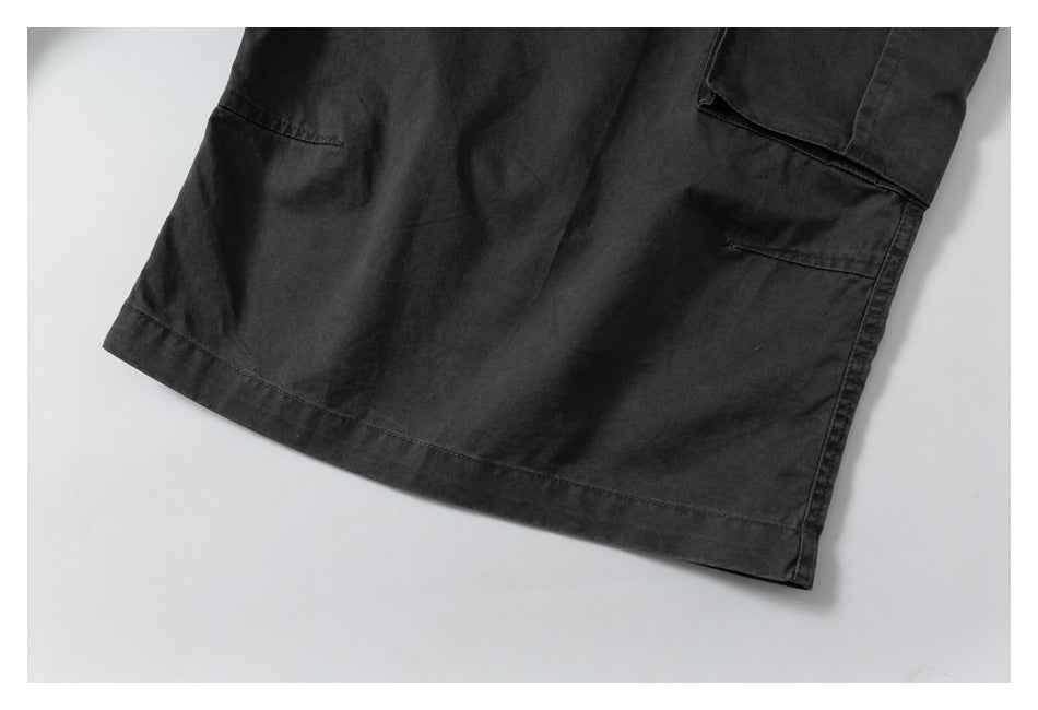 Close-up of the charcoal pants leg hem and lower pocket area.