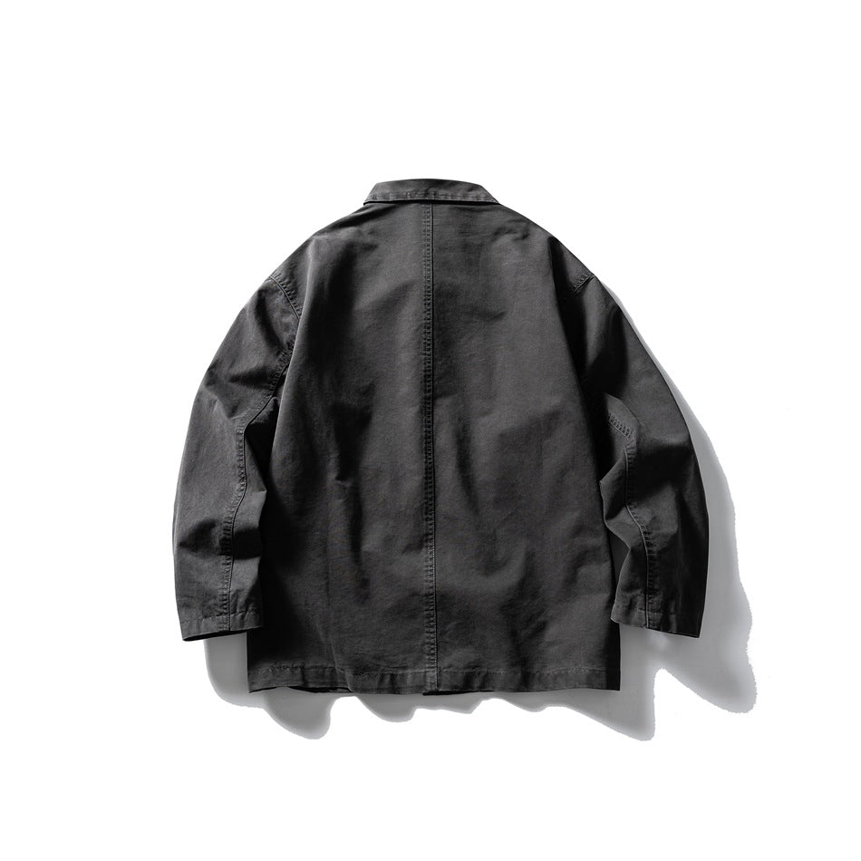 Back view of a dark grey work jacket with center back seam, collar and long sleeves, flat lay