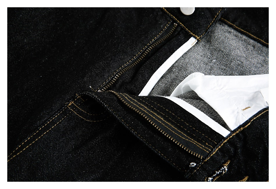 Close-up of the jeans' open zipper fly, waistband button and inner facing.