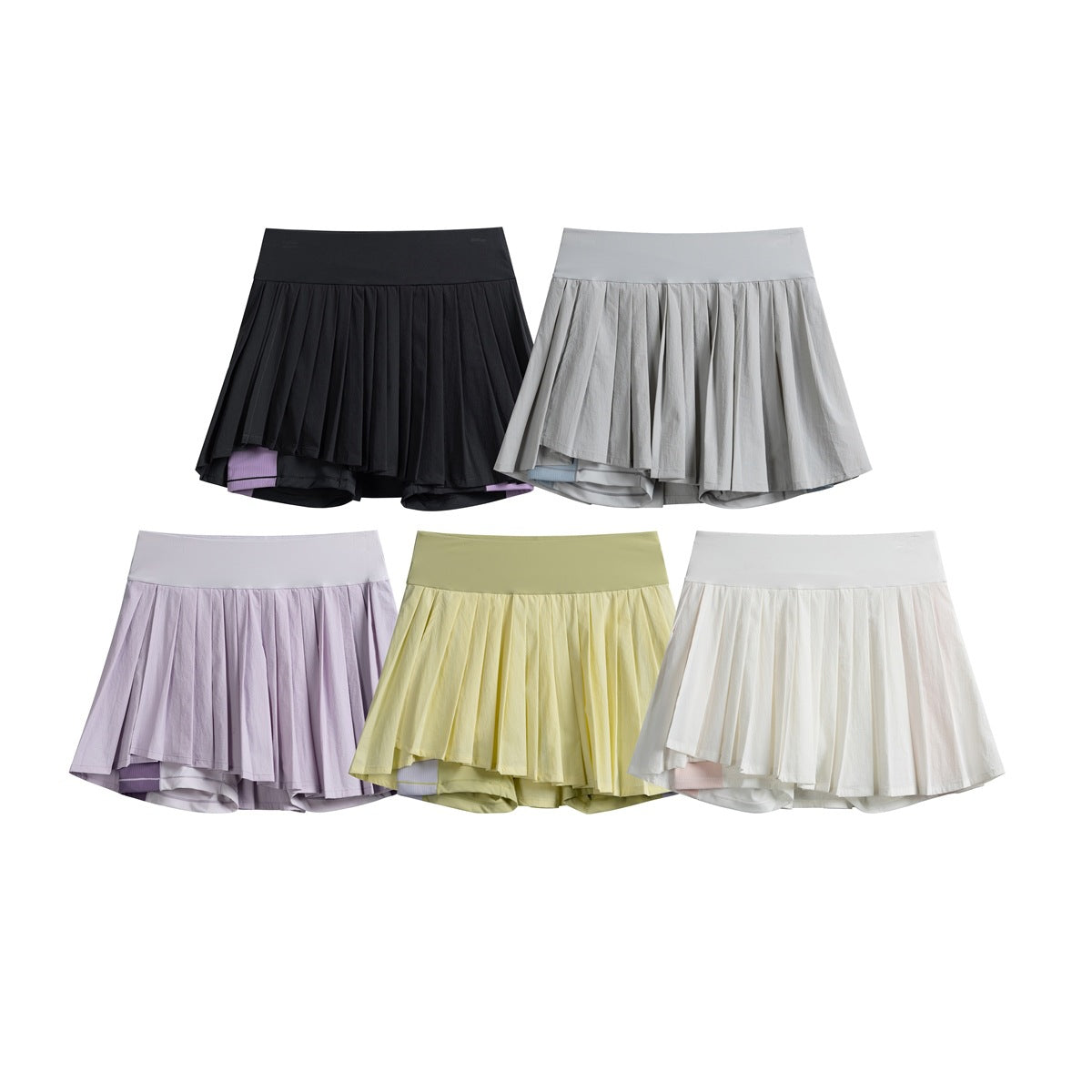 Five pleated athletic skirts with built-in shorts shown in black, gray, lilac, pale yellow, and white.