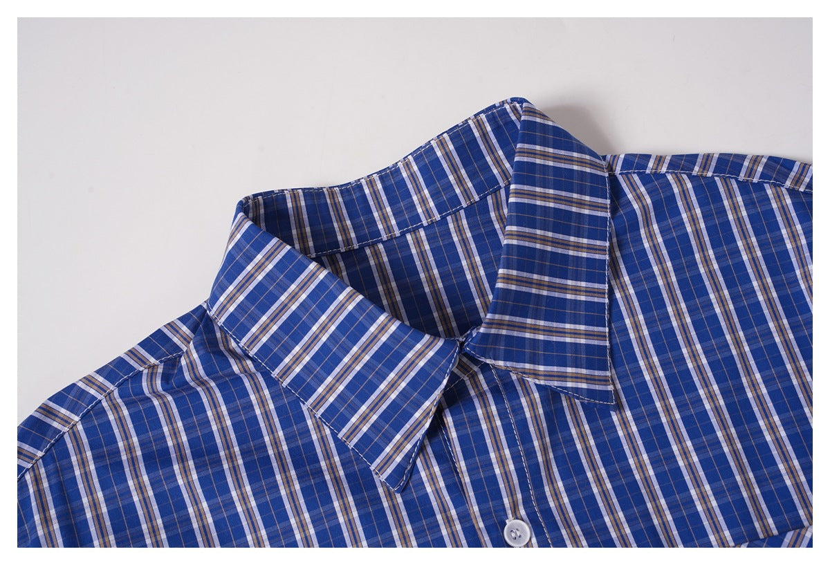 Close-up of the collar and upper chest of a blue plaid button-up shirt.