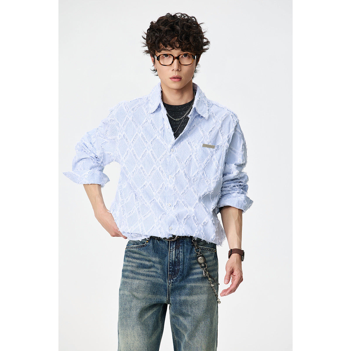 Front view of a model wearing a pale blue pinstriped button-up shirt with raised white diamond detailing.