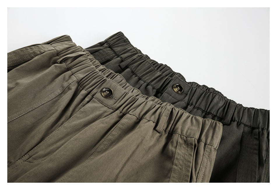 Close-up of two trouser colorways showing gathered elastic waistbands, buttons and front pocket openings.