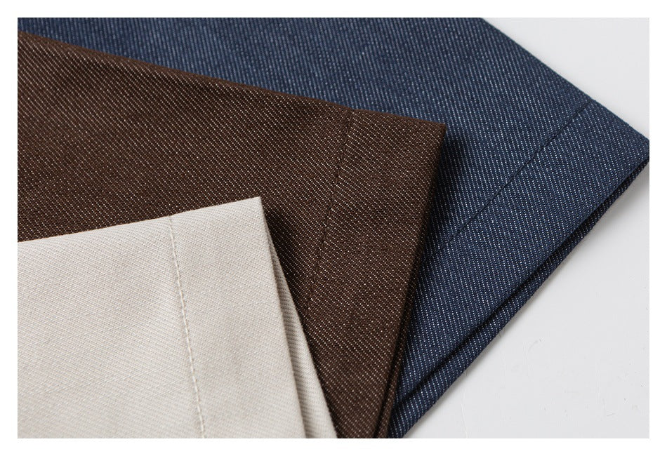 Close-up of beige, brown, and dark blue fabric swatches showing their woven texture.