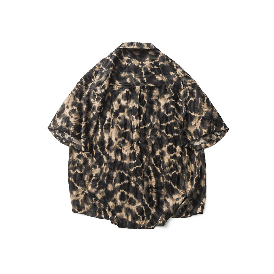 Flat-lay back view of a short-sleeve crinkled leopard-print shirt in black and tan