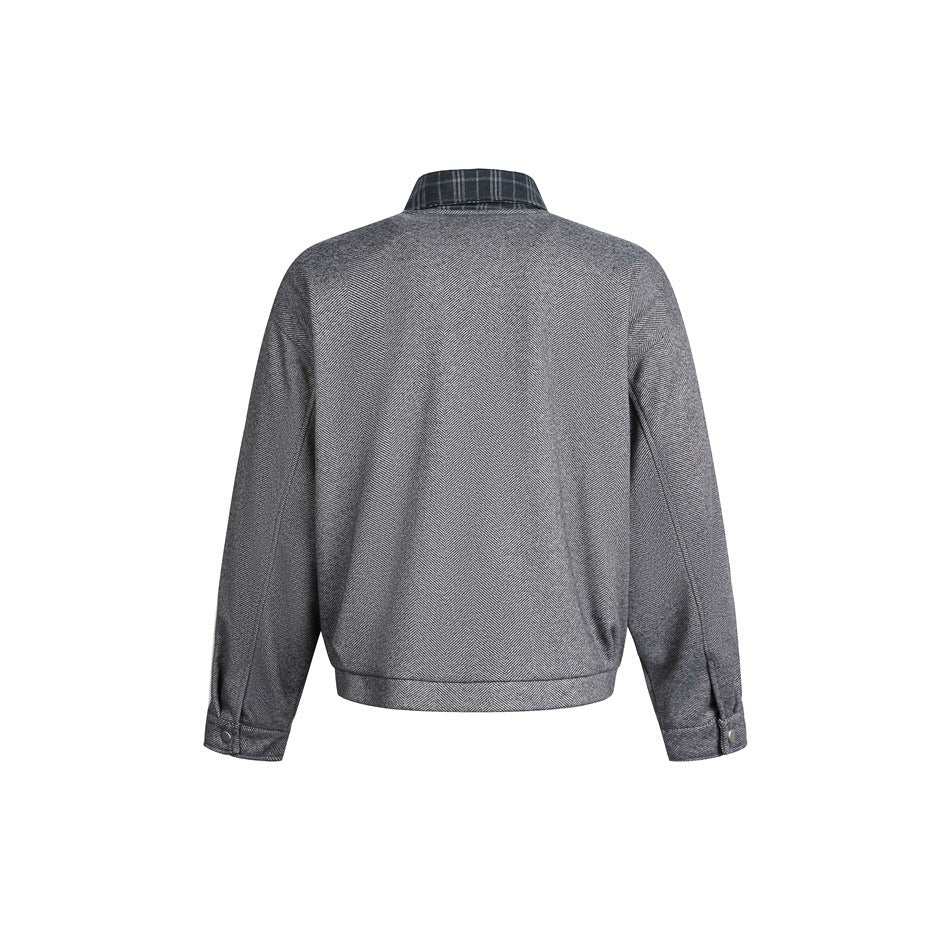 Back view of a gray herringbone jacket with a plaid collar and buttoned cuffs on a white background.