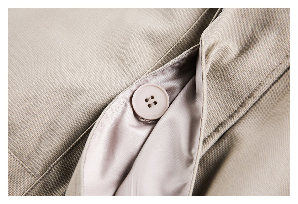 Close-up of a pale button and smooth lining inside a beige garment.