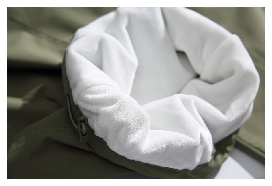 Close-up of plush white lining inside an olive-green garment, beside a drawcord toggle.