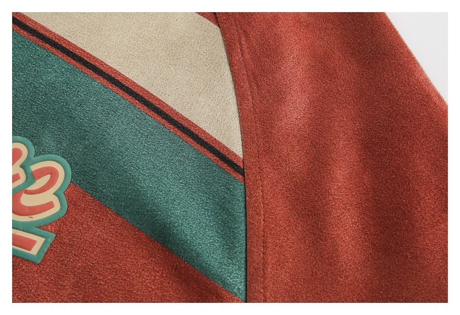 Close-up of a rust-colored sleeve beside striped fabric and part of a coral garment graphic.