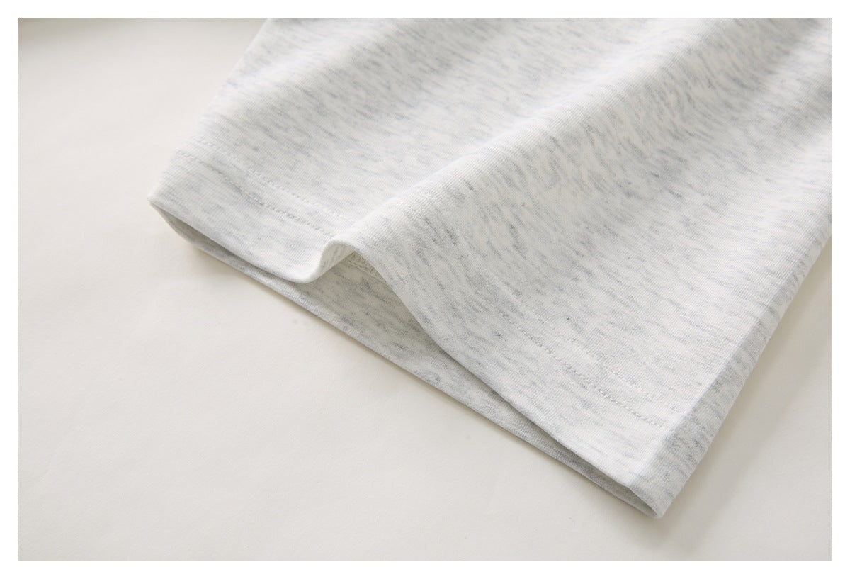 Close-up of the light gray heather polo shirt’s sleeve cuff and hem stitching.