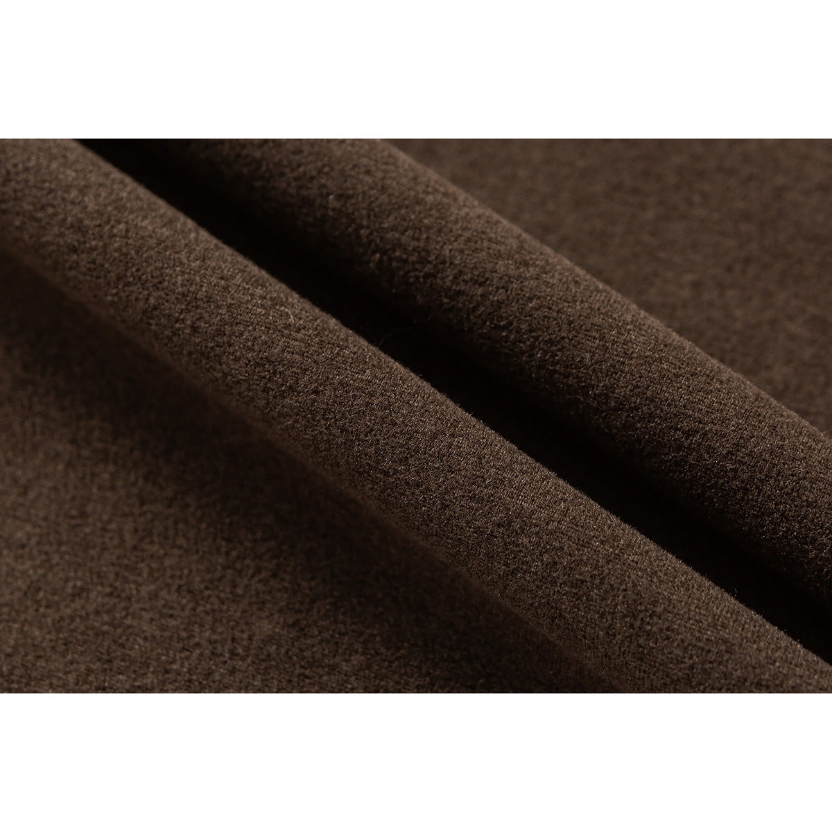 Macro view of dark brown fabric draped in folds, showing its textured surface.
