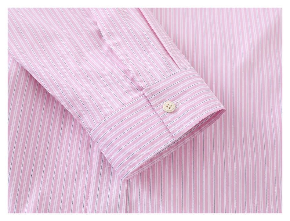 Close-up of a pink-and-white striped sleeve cuff with a cream button.
