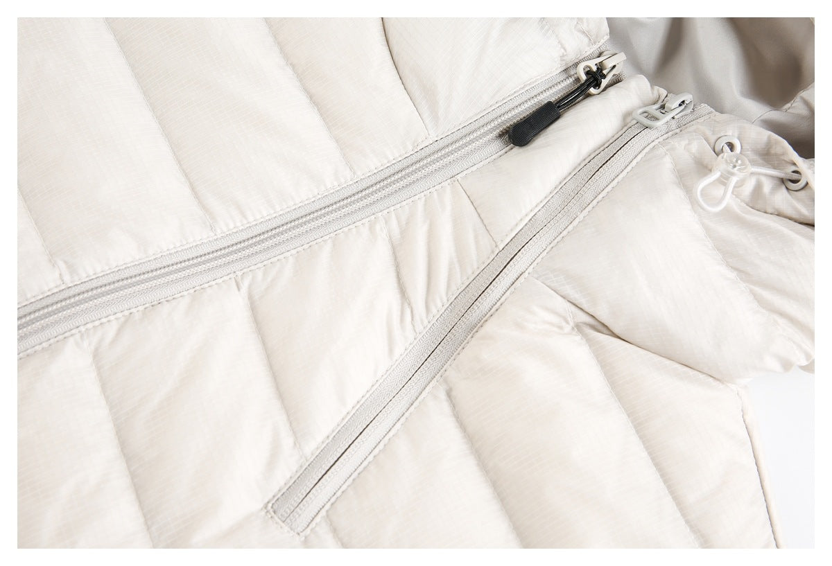 Close-up of the off-white quilted jacket showing its front zipper and diagonal pocket zipper.