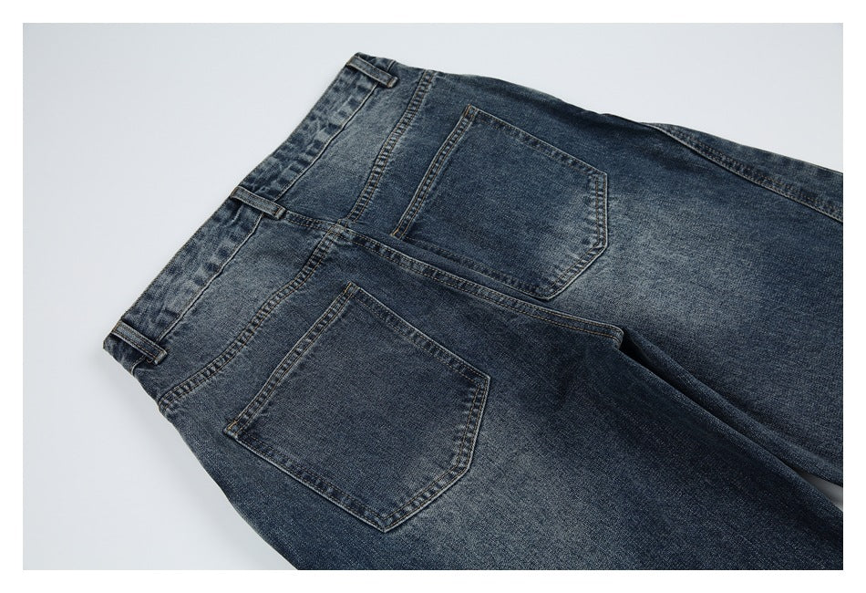Blue denim jeans laid flat, viewed from the back, with two rear pockets and belt loops.