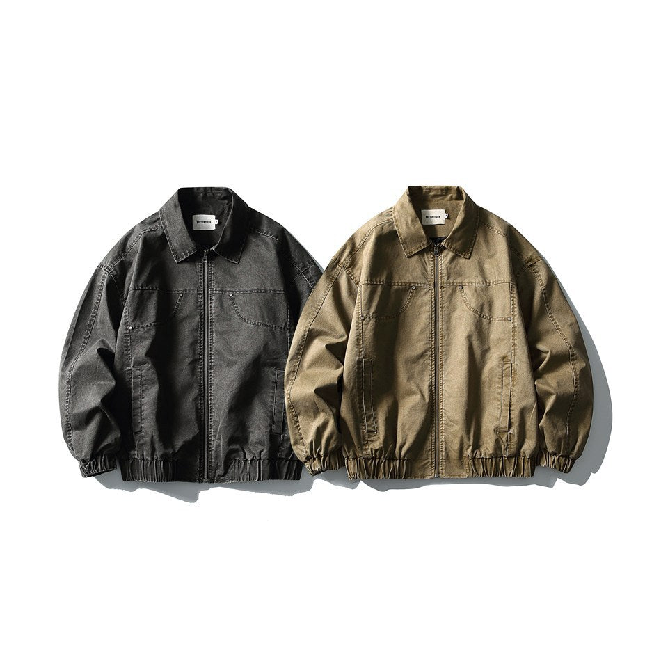 Two front-facing zip jackets with collars and elastic hems, in charcoal and tan-brown.
