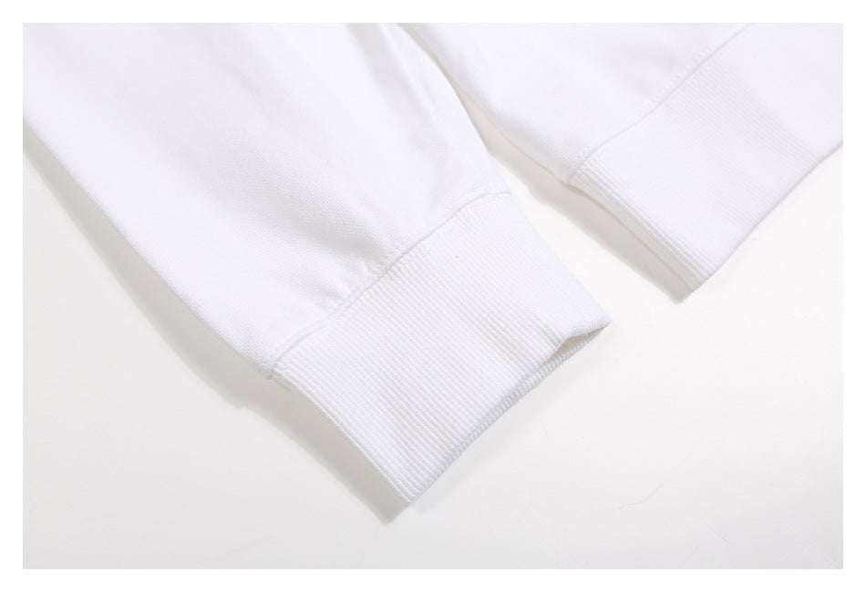 Close-up of two white sweatshirt sleeves showing ribbed cuffs and seam stitching.