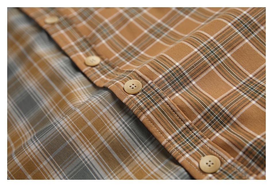 Close-up of the brown plaid shirt's button placket beside a contrasting gray plaid panel.