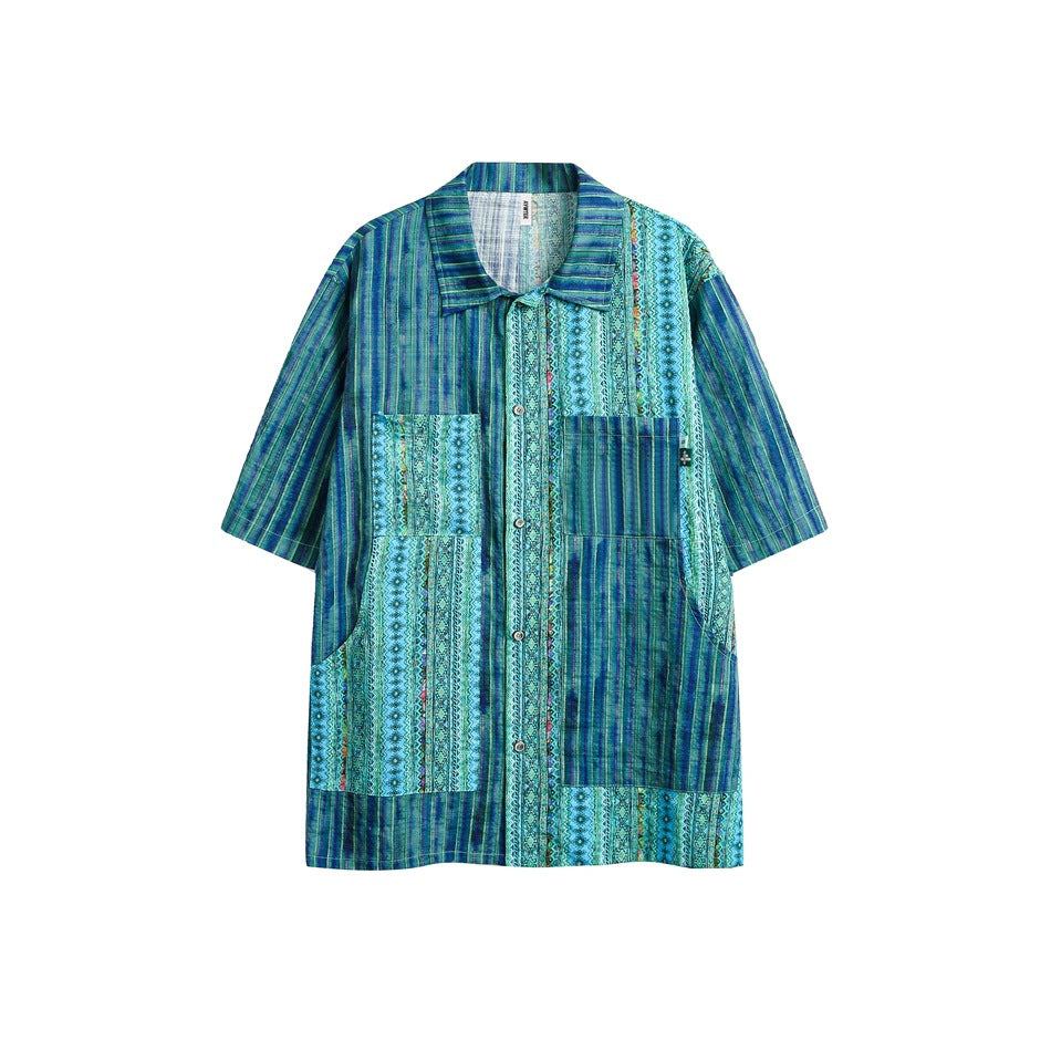 Blue and green striped patchwork short-sleeve button-up shirt with two patch pockets, flat front view