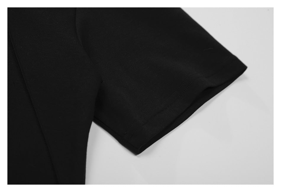 Close-up of a black short sleeve and its double-stitched hem.