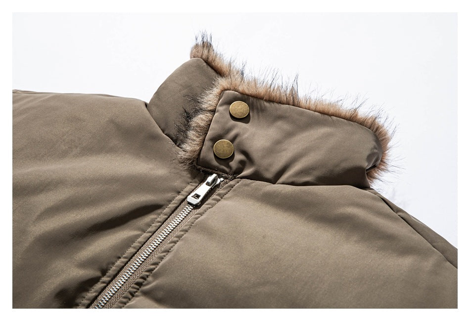 Close-up of a taupe padded coat collar with brown fur trim, two brass-tone snaps, and a silver zipper.
