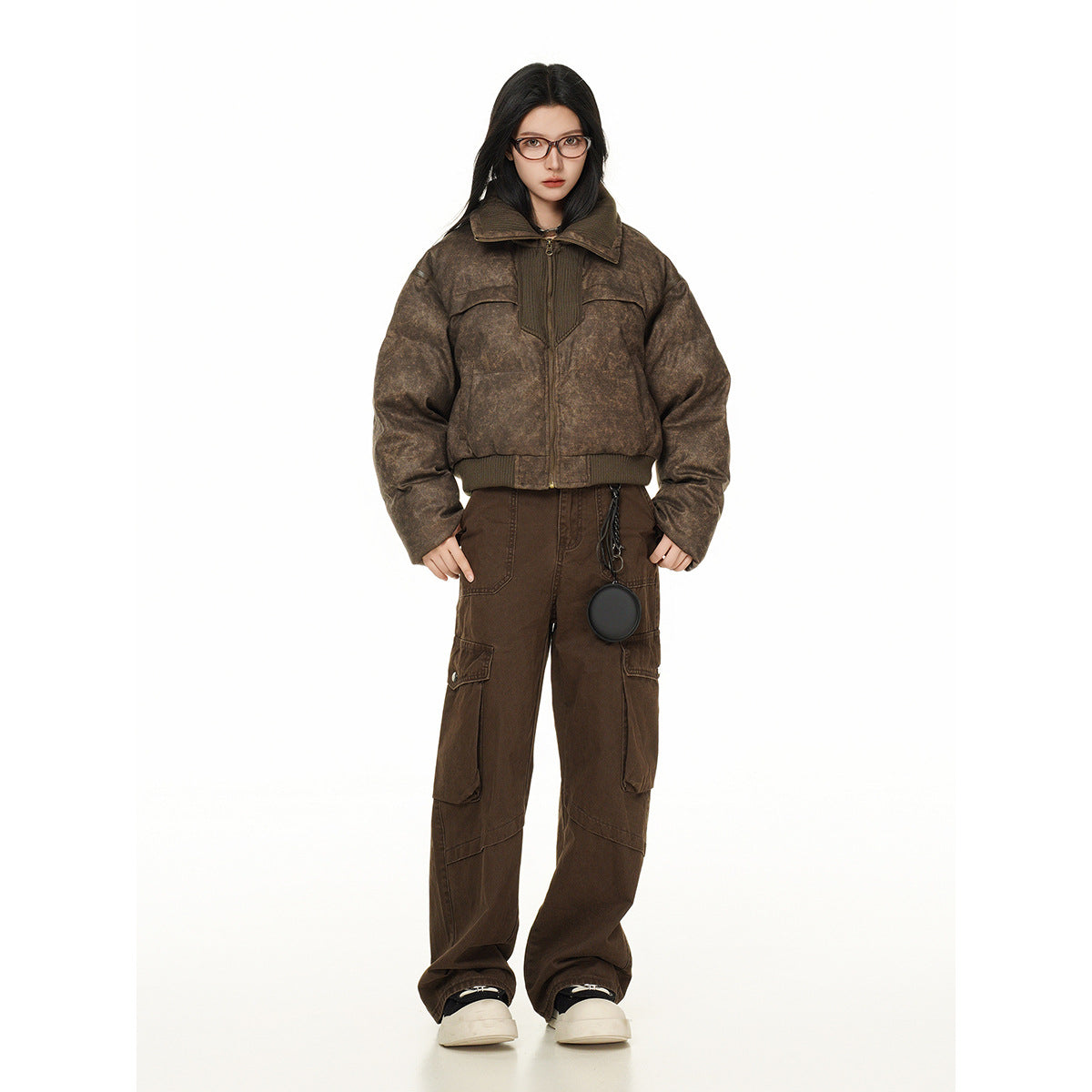 Model wearing a mottled brown cropped zip jacket with a wide collar and dark brown cargo pants, shown full-length from the