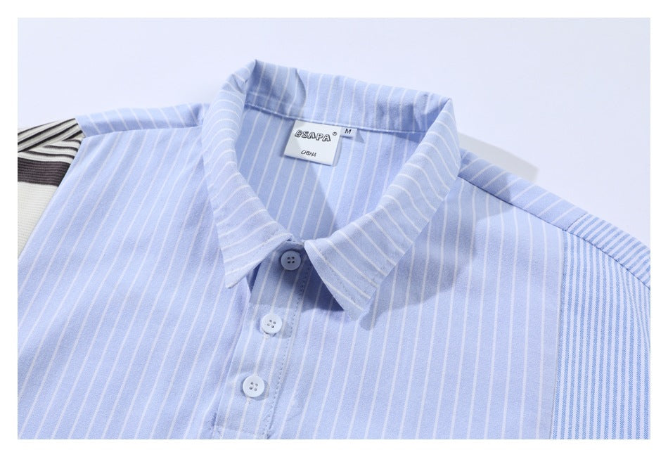 Flat-lay close-up of a light blue striped shirt with a pointed collar and short button placket.