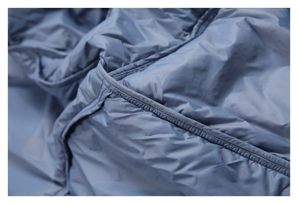 Close-up of a double-stitched seam on the blue jacket fabric.